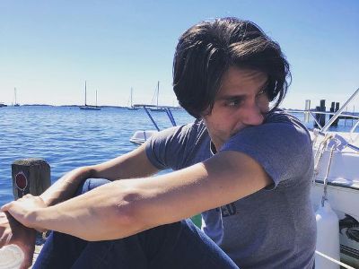 Gideon Glick is sitting at the dock as he enjoys the sea view.